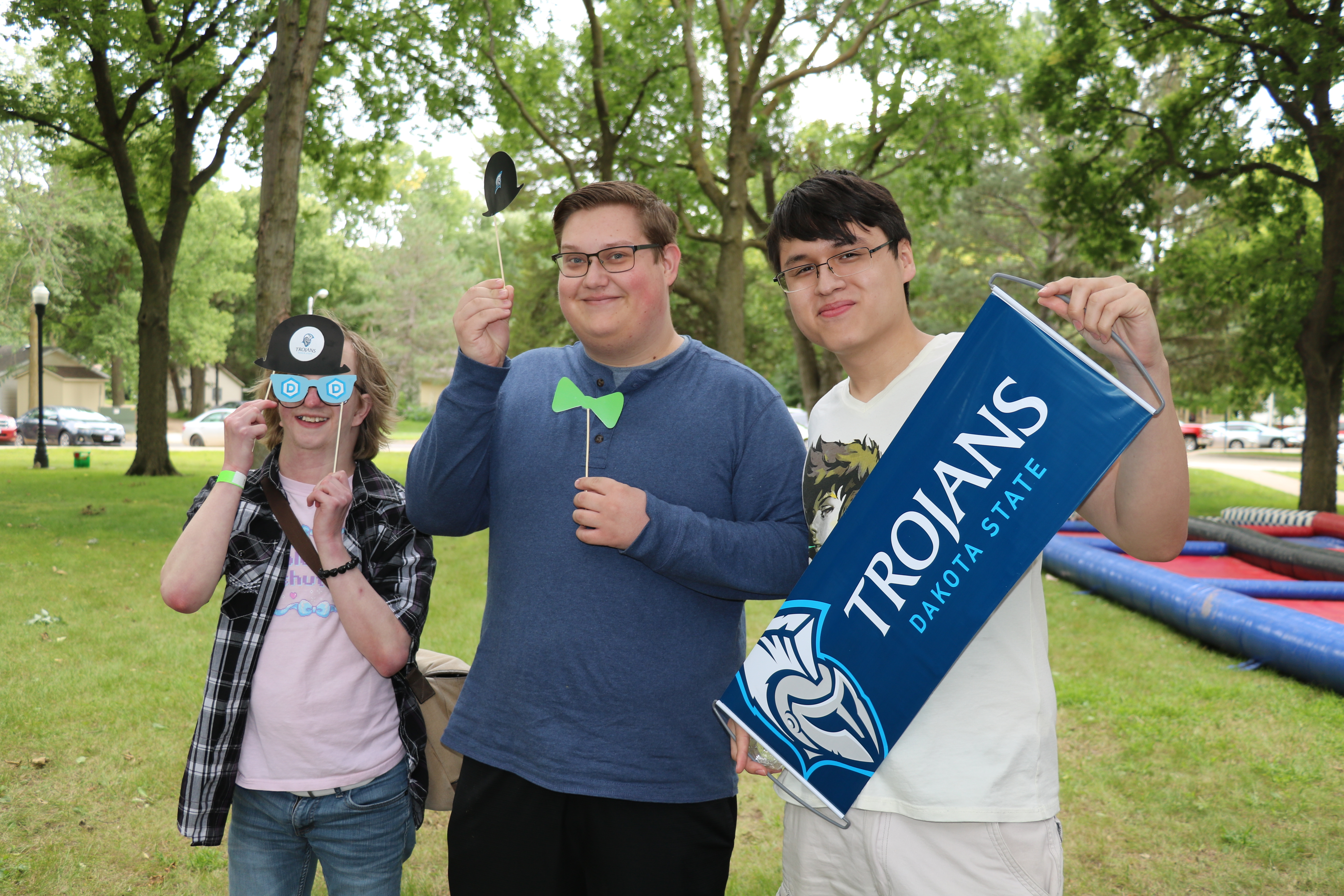 three male students outside on the Dakota State campus